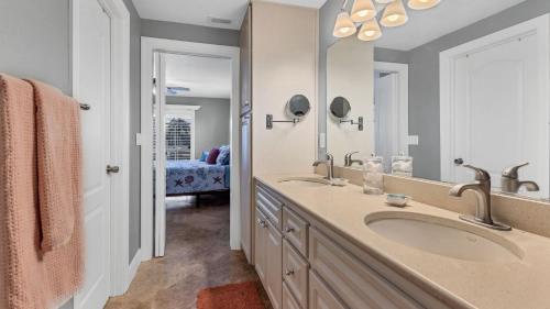a bathroom with two sinks and a large mirror at NPL829 in Punta Gorda