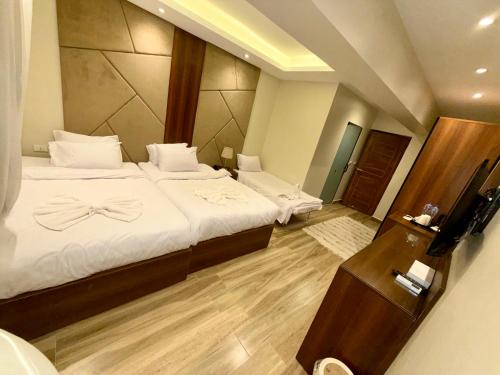 a bedroom with a bed with a bow on it at Giza Palace Pyramids View in Cairo