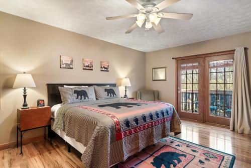 a bedroom with a bed and a ceiling fan at Berry Springs Lodge in Sevierville