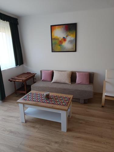 a living room with a couch and a table at City-Apartman in Kaposvár