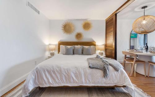 a bedroom with a bed and a desk and a table at Sea La Vie at Sapphire Beach Resort & Marina in East End