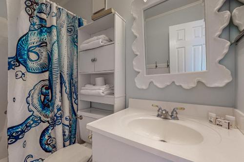 a bathroom with a sink and a shower curtain at Island Beach & Racquet Club G210 in Atlantic Beach