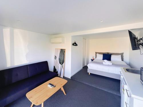 a living room with a couch and a bed at Lake view retreat Studio in Queenstown