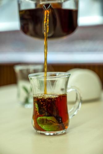 a cup of tea is being poured into it at Soft Hotel in Cairo