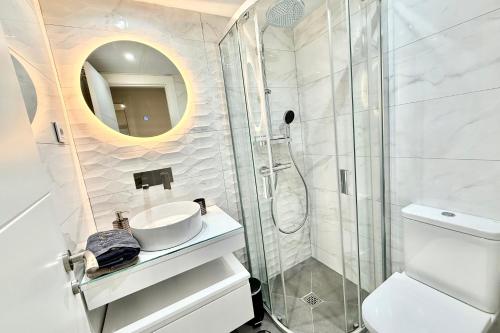 a white bathroom with a sink and a shower at MARBELLA ALICATE BEACHFRONT - Luxury Apartment-1 in Marbella