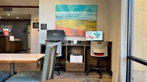 an office with a desk with a computer and chairs at Hampton Inn by Hilton Montrose in Montrose