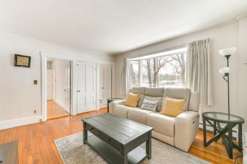 a living room with a couch and a table at 16 Mi to Boston Home with Deck in Weymouth in Weymouth