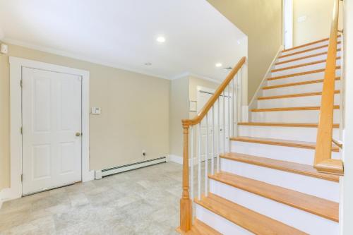 a staircase in a home with white walls at 16 Mi to Boston Home with Deck in Weymouth in Weymouth