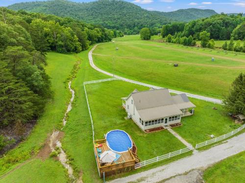 an aerial view of a house with a pool in a field at Hidden Treasure in Stanton