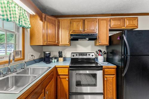 a kitchen with wooden cabinets and a stove top oven at Hidden Treasure in Stanton