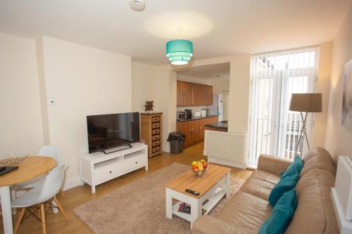 a living room with a couch and a table at Norton Serviced Apartments in Stockton-on-Tees