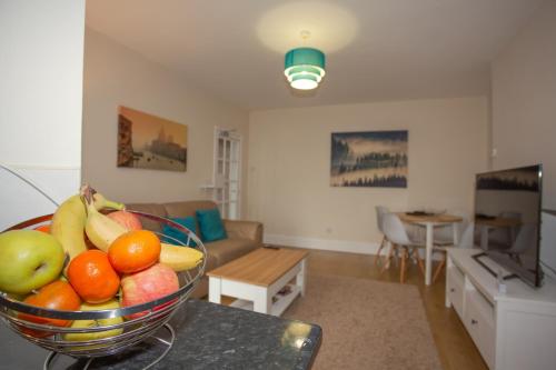 a bowl of fruit on a table in a living room at Norton Serviced Apartments in Stockton-on-Tees