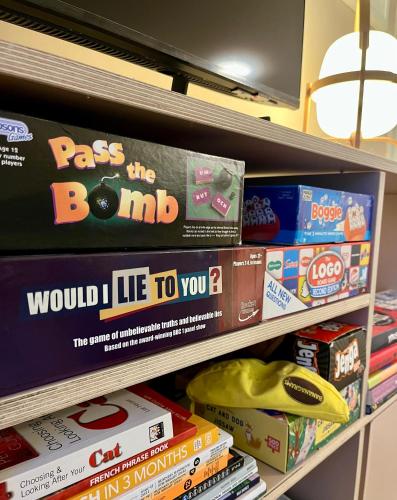 a shelf in a store filled with board games at The Shades - Bliss In The Heart of Windermere in Windermere