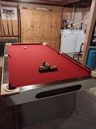 a pool table in a kitchen with a red top at 5H Charming Hilltop Farmhouse with Stunning Views & Modern Comforts Near Mountain View Grand Resort in Whitefield