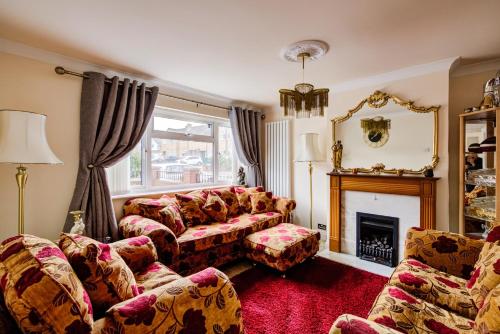 a living room with a couch and a fireplace at Luxury - 4 BHK Semi Detached House in Chelmsford