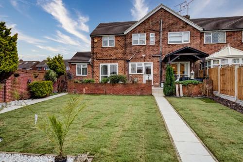 a brick house with a lawn in front of it at Luxury - 4 BHK Semi Detached House in Chelmsford