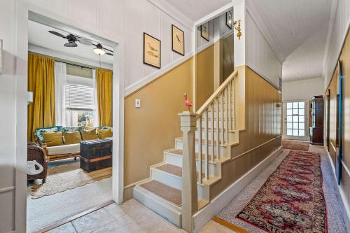 a hallway with a staircase in a home at Old Carrabelle Hotel Flamingo Suite in Carrabelle