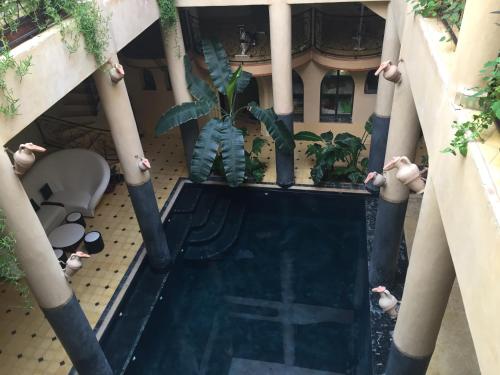 an overhead view of a pool in a building with plants at Kasbah Titrit & Spa in Aït Ben Haddou