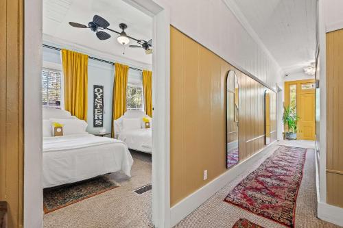 a bedroom with two beds and a hallway at Old Carrabelle Hotel Captains Quarters Suite in Carrabelle