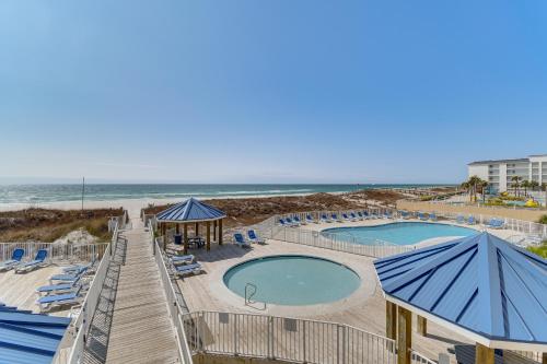 a resort with two pools and chairs and the beach at Orange Beach Retreat with 4 Pools - Walk to Beach! in Gulf Shores