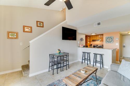 a living room with a couch and a table at Orange Beach Retreat with 4 Pools - Walk to Beach! in Gulf Shores