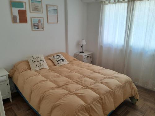 a bed in a bedroom with two pillows on it at Depto 1 cuadra del mar Casino Cochera auto Solo familias in Mar del Plata