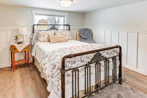 a bedroom with a bed with a floral bedspread at 1 Mi to Main Street Polson Updated Home with Deck! in Polson