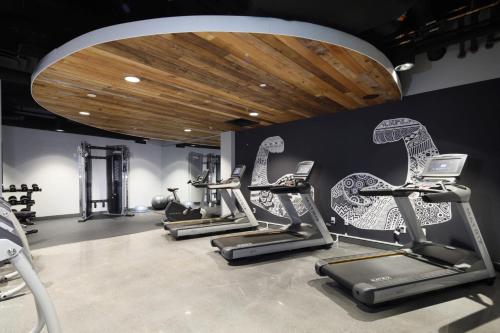 a gym with several cardio machines in a row at Hotel Indigo Chattanooga - Downtown by IHG in Chattanooga