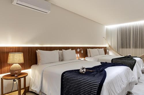 Giường trong phòng chung tại Casa Manawa Milagres