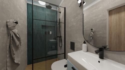 a bathroom with a shower and a toilet and a sink at Ośrodek Wypoczynkowy CHAMPION in Władysławowo