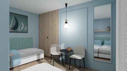 a bedroom with a bed and a table and chairs at Ośrodek Wypoczynkowy CHAMPION in Władysławowo