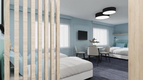 a bedroom with two beds and a table with chairs at Ośrodek Wypoczynkowy CHAMPION in Władysławowo