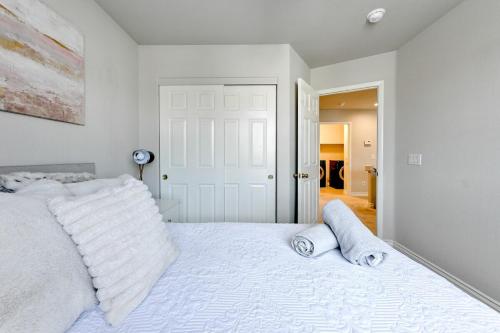 a bedroom with a white bed with two pillows at Vila Amor- Pool, Games and Ultimate Vegas Vibes in Las Vegas