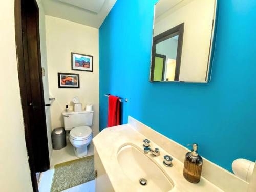 a blue bathroom with a sink and a toilet at RLL Breathtaking views and grand unique style in Dalton