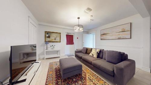 a living room with a couch and a chair at Comfortable & Spacious Private Room with Ensuite in Corso Italia in Toronto