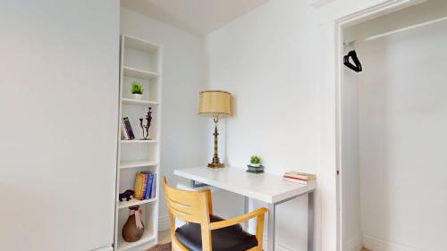 a white desk with a lamp and a chair at Comfortable & Spacious Private Room with Ensuite in Corso Italia in Toronto