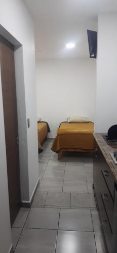 a room with a bed and a tiled floor at Estudios Quintana in Arandas