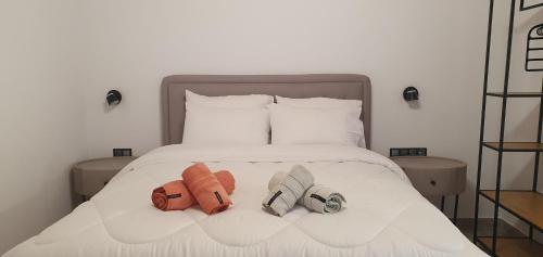a bedroom with a bed with two slippers on it at Hephaestus Appartments Litochoro A3 in Litochoro