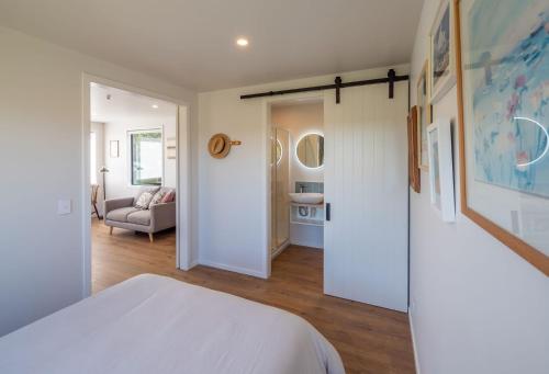 a bedroom with a bed and a living room at Tui Studio in Pohara