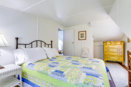 a bedroom with a bed and a dresser at Lakefront Cottage with Covered Porch and Dock! in Coventry