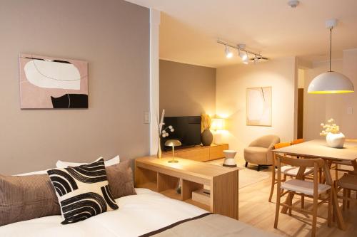 a living room with a couch and a table at 末松ビル -Tokyo lifestyle apartment- in Tokyo