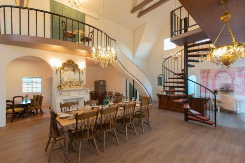 a dining room with tables and chairs in a building at Paris De Floor Khaoyai in Pak Chong