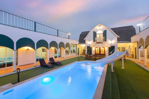 a swimming pool with a slide in a house at Paris De Floor Khaoyai in Pak Chong