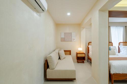 a room with a couch and two beds in it at Wayan House with Hotspring Pool in Los Baños