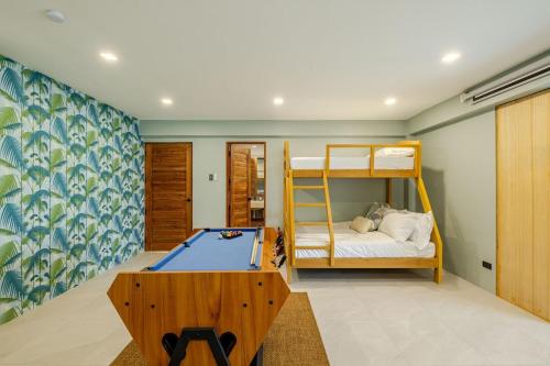 a bedroom with a pool table and a bunk bed at Wayan House with Hotspring Pool in Los Baños
