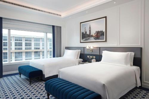 a hotel room with two beds and a window at Londoner Grand, a Luxury Collection Hotel, Macau in Macau