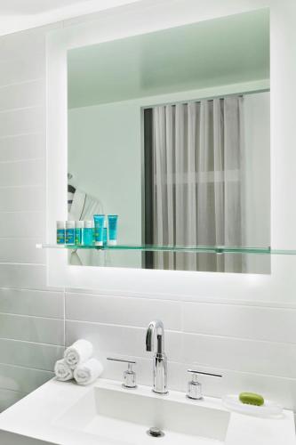 a bathroom with a sink and a mirror at The Wade in Chicago