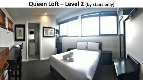 a bedroom with a white bed and a window at Dunsborough Bay Village Resort Suites in Dunsborough