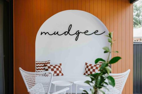 a white table with chairs and a sign that readsilage at Kirsten Accommodation Mudgee in Mudgee