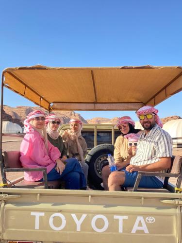 a group of people sitting in a golf cart at Rum rose luxury camp in Wadi Rum